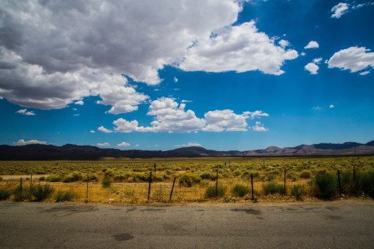 The view of distant mountains and clouds, as seen from the Coso Junction Rest Area.